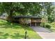 Beautiful home featuring stone accents, a two-car garage, and a spacious deck nestled amongst mature trees at 2600 Sandpiper Dr, Tucker, GA 30084