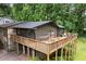 Exterior features stone accents, upper deck with patio furniture and a hammock, and a lower garage at 2600 Sandpiper Dr, Tucker, GA 30084