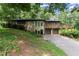 Stone and siding home with a spacious driveway, two-car garage and elevated deck with scenic views at 2600 Sandpiper Dr, Tucker, GA 30084