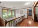 Sunlit hallway with hardwood floors, a decorative chandelier, and views of the outdoors at 2600 Sandpiper Dr, Tucker, GA 30084