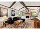 Comfortable living room featuring wood beams, brick fireplace, and hardwood floors at 2600 Sandpiper Dr, Tucker, GA 30084