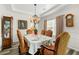 Elegant dining room with a chandelier, hardwood floors, and a formal dining table with seating for six at 58 Lilyfield Ln, Acworth, GA 30101
