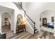 Bright foyer features hardwood floors, a staircase with black and white risers, and elegant decor at 58 Lilyfield Ln, Acworth, GA 30101