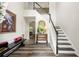 Bright foyer features hardwood floors, a staircase with black and white risers, and elegant decor at 58 Lilyfield Ln, Acworth, GA 30101