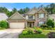 Charming two-story home featuring brick and stone accents, a well-manicured lawn, and a two-car garage at 58 Lilyfield Ln, Acworth, GA 30101