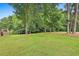 Expansive backyard offers ample space for recreation with lush greenery and mature trees at 245 Maple Shade Dr, Tyrone, GA 30290