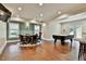 Basement game room boasts recessed lighting, wood floors, and a poker table for entertaining guests at 245 Maple Shade Dr, Tyrone, GA 30290