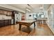 Spacious basement featuring a pool table, kitchenette with stainless steel appliances, and a bar area with seating at 245 Maple Shade Dr, Tyrone, GA 30290