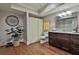 Bathroom with a walk-in shower, decorative mirror and granite countertops, plus a decorative houseplant at 245 Maple Shade Dr, Tyrone, GA 30290