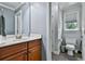 Well-lit bathroom with granite countertops, sink, and toilet at 245 Maple Shade Dr, Tyrone, GA 30290