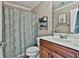 Bathroom featuring a toilet, wood vanity, and shower curtain at 245 Maple Shade Dr, Tyrone, GA 30290