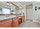 Double vanity bathroom with stone countertops, a large mirror, and sconces at 245 Maple Shade Dr, Tyrone, GA 30290