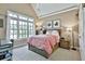 Bedroom with vaulted ceilings, large window, and warm decor at 245 Maple Shade Dr, Tyrone, GA 30290