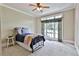 Cozy bedroom featuring a large window with seating and a ceiling fan at 245 Maple Shade Dr, Tyrone, GA 30290