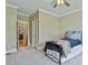 Bedroom with a comfortable bed, soft carpet, and a view into the hallway at 245 Maple Shade Dr, Tyrone, GA 30290