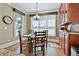Cozy dining area with a round table, natural light, and built-in cabinets at 245 Maple Shade Dr, Tyrone, GA 30290