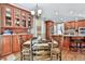 Open-concept dining area featuring wood floors and a built-in china cabinet at 245 Maple Shade Dr, Tyrone, GA 30290