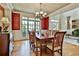 Elegant dining room with hardwood floors, ornate wallpaper, large windows, and a wooden table at 245 Maple Shade Dr, Tyrone, GA 30290