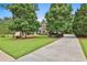 Beautiful home featuring a well-maintained lawn and a long driveway framed by mature trees at 245 Maple Shade Dr, Tyrone, GA 30290