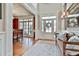 Bright foyer featuring hardwood floors, decorative rug, bench seating, and traditional accents at 245 Maple Shade Dr, Tyrone, GA 30290