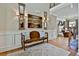 Foyer area showcasing hardwood floors, neutral walls, bench seating, and a view into living room at 245 Maple Shade Dr, Tyrone, GA 30290