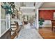 Welcoming foyer with hardwood floors, decorative rug, bench seating, and view into living room at 245 Maple Shade Dr, Tyrone, GA 30290
