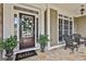 Close-up of a welcoming front door with decorative wreath and cozy seating on the porch at 245 Maple Shade Dr, Tyrone, GA 30290