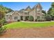 Inviting two-story home with manicured lawn and beautiful stone and siding exterior at 245 Maple Shade Dr, Tyrone, GA 30290