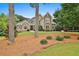 Charming home with a manicured front lawn, complemented by mature trees and lush landscaping at 245 Maple Shade Dr, Tyrone, GA 30290