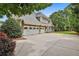 Spacious three-car garage with carriage doors, offering ample parking and storage at 245 Maple Shade Dr, Tyrone, GA 30290