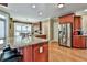Spacious kitchen with granite countertops, stainless steel appliances, and wood floors at 245 Maple Shade Dr, Tyrone, GA 30290