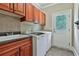 Laundry room with modern washer, dryer, sink, and cabinets at 245 Maple Shade Dr, Tyrone, GA 30290