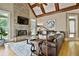 Cozy living room with a stone fireplace, large windows, and wood beam ceiling at 245 Maple Shade Dr, Tyrone, GA 30290