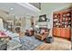 Open living room featuring a fireplace, built-in shelving, and hardwood floors at 245 Maple Shade Dr, Tyrone, GA 30290
