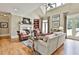 Inviting living room featuring a fireplace, high ceilings, and ample natural light at 245 Maple Shade Dr, Tyrone, GA 30290