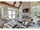 Inviting living room featuring a stone fireplace, beamed ceilings, and outdoor access at 245 Maple Shade Dr, Tyrone, GA 30290