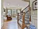Staircase leads to the spacious living room featuring a fireplace and natural light from large windows at 245 Maple Shade Dr, Tyrone, GA 30290