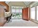 Sunlit office space featuring a built-in desk, large windows, and outdoor views at 245 Maple Shade Dr, Tyrone, GA 30290