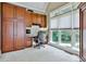 Well-lit office space with custom built-ins and a large window overlooking a lush backyard at 245 Maple Shade Dr, Tyrone, GA 30290