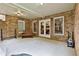 Covered patio with brick accents, bench seating, and a view of the backyard at 245 Maple Shade Dr, Tyrone, GA 30290