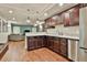 Basement wet bar with stainless appliances and granite counters, adjacent to a recreation area at 245 Maple Shade Dr, Tyrone, GA 30290
