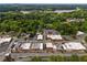 This aerial view showcases the businesses in the area and its proximity to a gorgeous lake and green, mature trees at 4520 Dallas St, Acworth, GA 30101