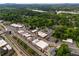 This aerial view shows a commercial district with train tracks and the proximity to the lake and mature trees at 4520 Dallas St, Acworth, GA 30101