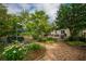 Landscaped backyard with a patio, a deck, and mature trees offering privacy and shade at 4520 Dallas St, Acworth, GA 30101