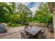 A spacious wooden deck with a table set features lush green foliage and landscaping at 4520 Dallas St, Acworth, GA 30101