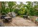 A spacious backyard with a wooden deck, outdoor grills, and lush green foliage and landscaping at 4520 Dallas St, Acworth, GA 30101