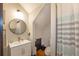 Charming bathroom features modern fixtures, round mirror, and patterned shower curtain at 4520 Dallas St, Acworth, GA 30101