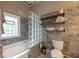 Unique bathroom featuring a tub and a half wall made of glass block at 4520 Dallas St, Acworth, GA 30101