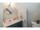 Compact bathroom features a stylish vanity, modern faucet, and a round mirror with brass accents at 4520 Dallas St, Acworth, GA 30101