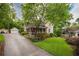 Charming home featuring a screened-in porch, lush landscaping, and a detached garage at 4520 Dallas St, Acworth, GA 30101